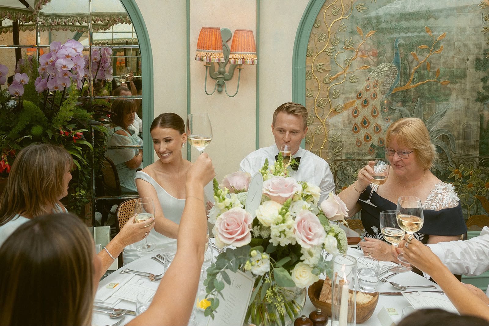 Wedding reception toast with pink rose centrepiece
