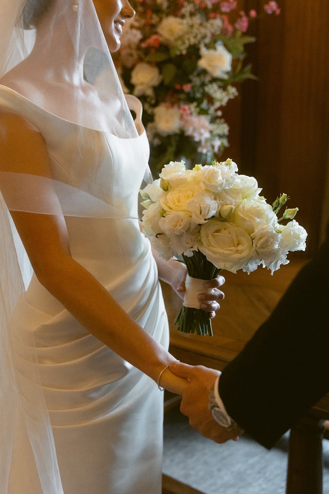 Bride holding hands with groom at ceremony